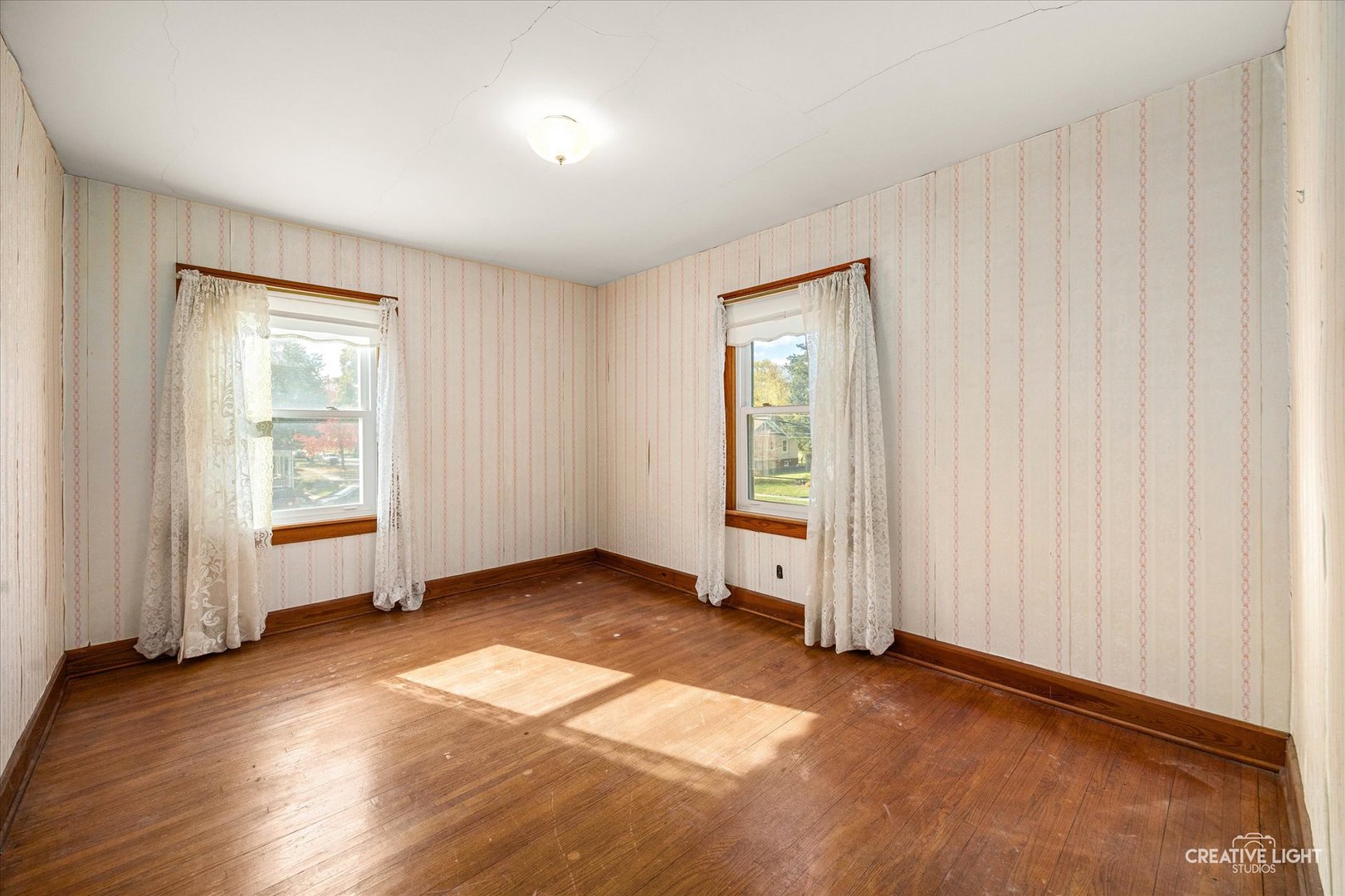 363 Orchard Street Elgin, IL 60123 - Photo 16 of 27 an empty room with wooden floor and windows