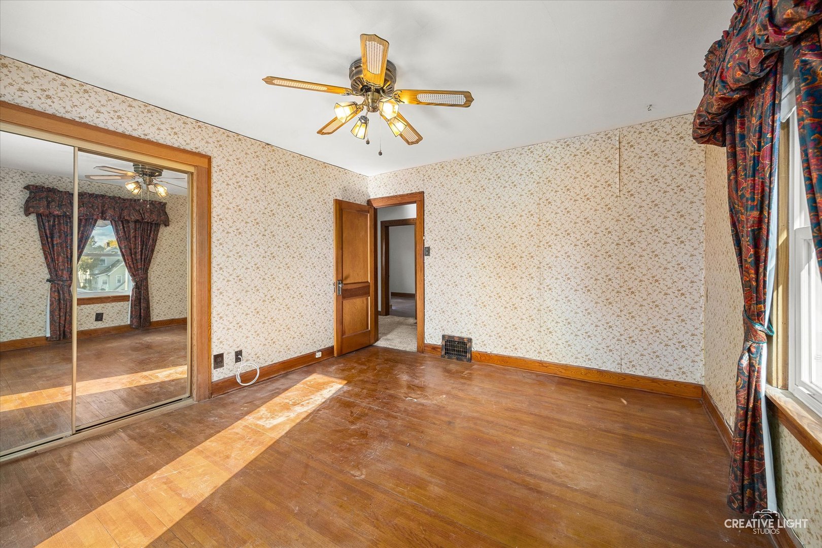 363 Orchard Street Elgin, IL 60123 - Photo 18 of 27 a view of an empty room with window and wooden floor