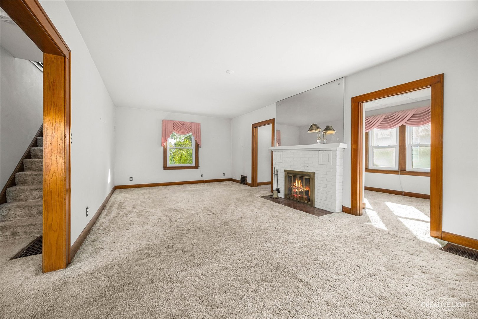 363 Orchard Street Elgin, IL 60123 - Photo 5 of 27 a view of a livingroom with an empty space and a fireplace