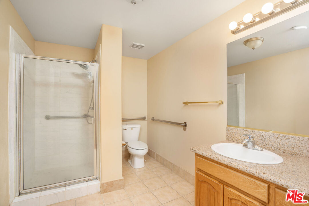 1128 West Duarte Road, Unit A Arcadia, CA 91007 - Photo 15 of 28 a bathroom with a granite countertop sink toilet and shower