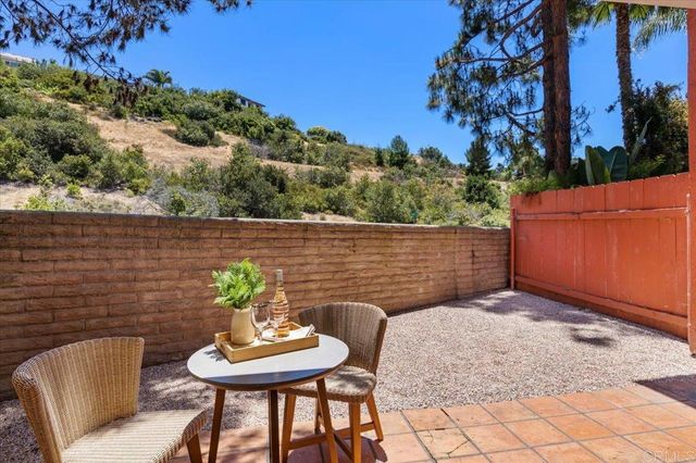 a backyard of a house with table and chairs
