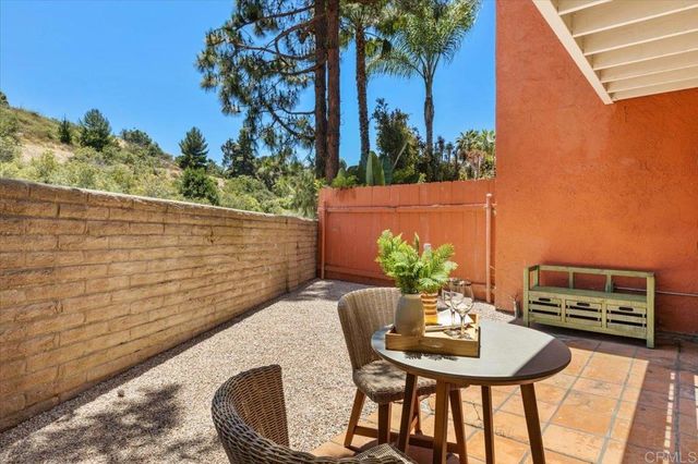 a view of a patio with table and chairs near a tree