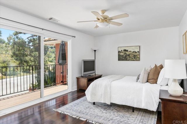 a bedroom with bed and a chandelier