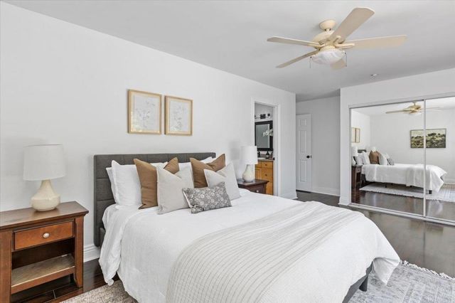 a bedroom with a bed and wooden floor