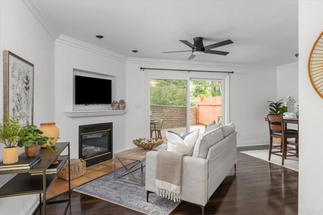 a living room with furniture a fireplace and a flat screen tv