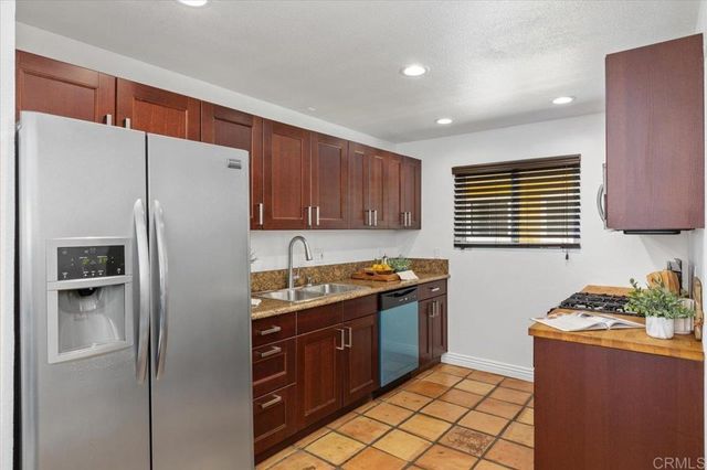 a kitchen with stainless steel appliances granite countertop a sink stove and cabinets