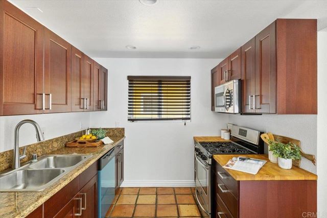 a kitchen with a stove a microwave and wooden cabinets