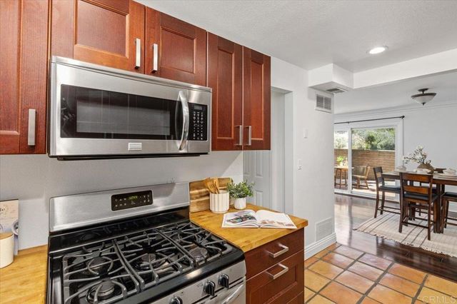 a kitchen with stainless steel appliances granite countertop a sink stove and cabinets