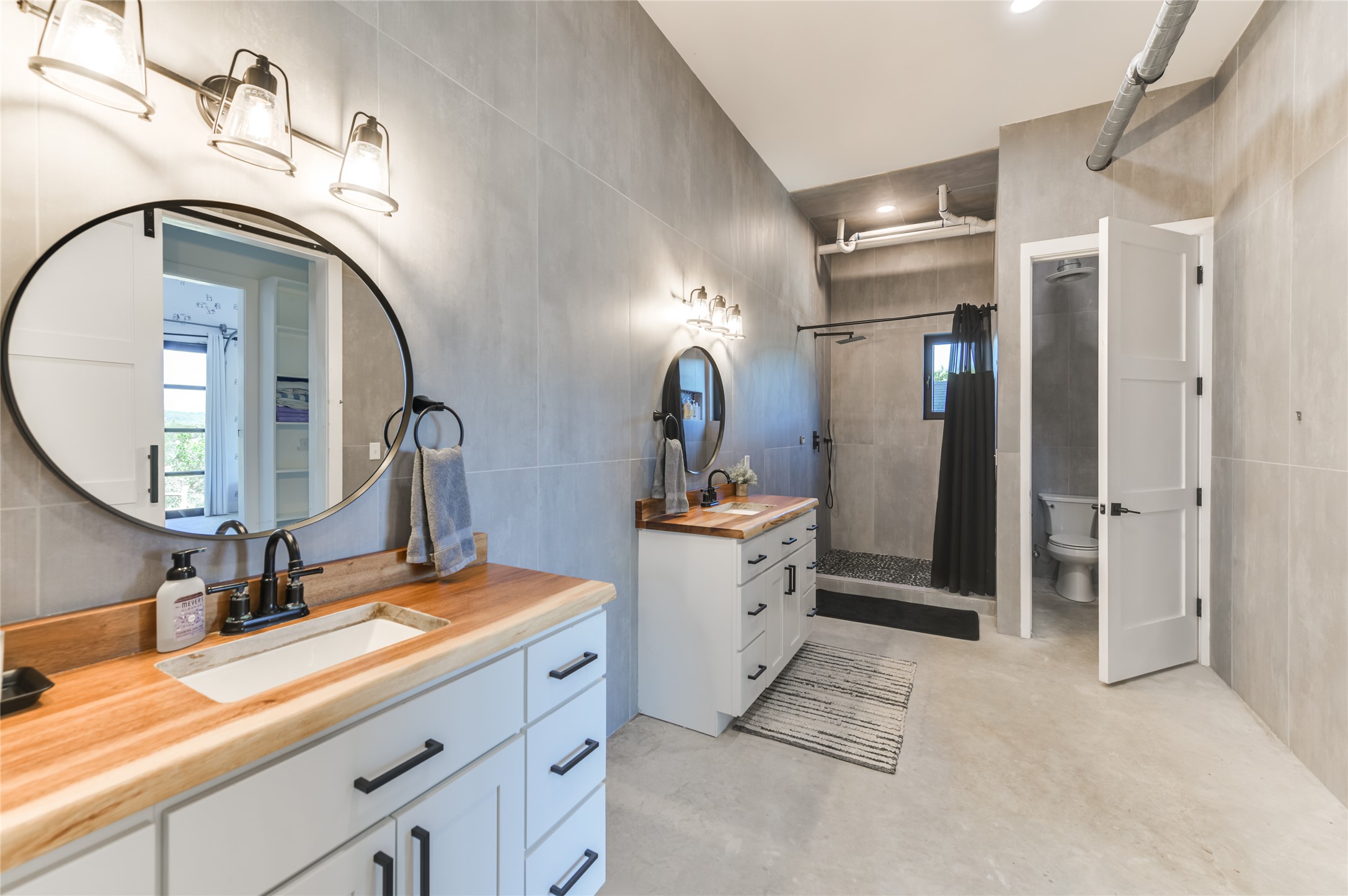 0 Trails End Road Leander, TX 78641 - Photo 17 of 40 a bathroom with a double vanity sink mirror and shower