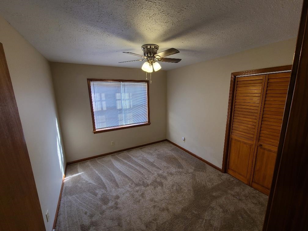 3478 Cane Ridge Drive Memphis, TN 38109 - Photo 11 of 19 an empty room with windows and fan