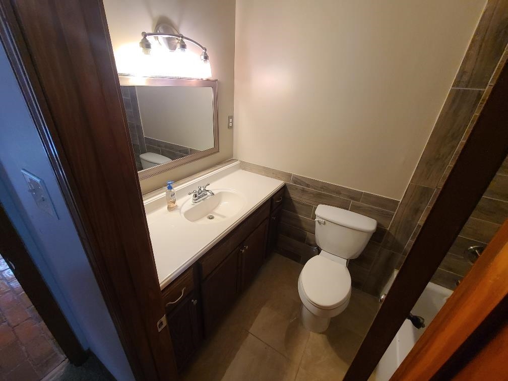 3478 Cane Ridge Drive Memphis, TN 38109 - Photo 15 of 19 a bathroom with a toilet sink and mirror