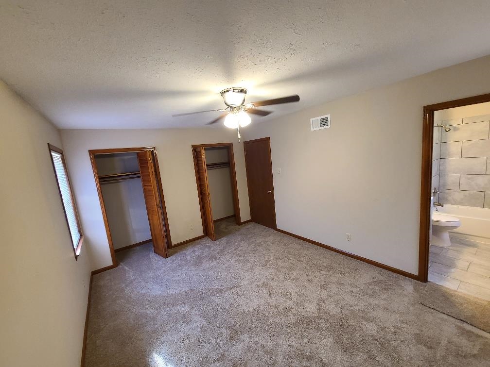 3478 Cane Ridge Drive Memphis, TN 38109 - Photo 16 of 19 an empty room with closet and a ceiling fan