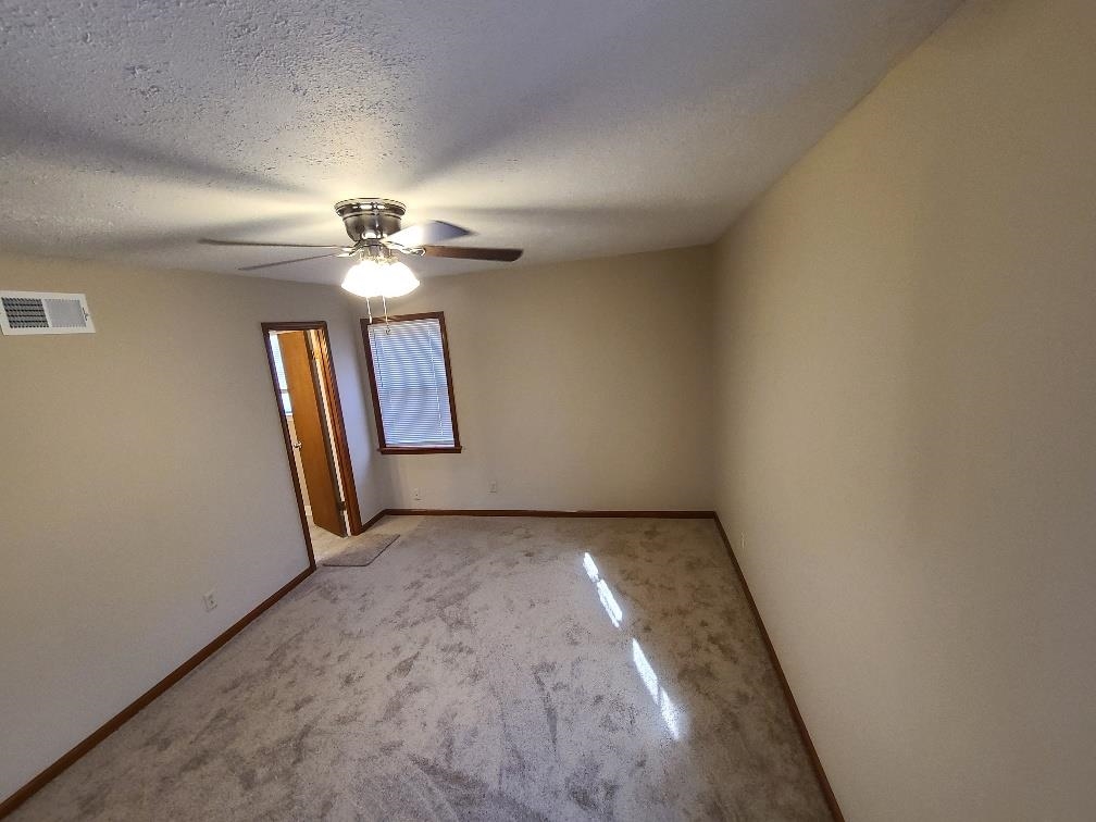 3478 Cane Ridge Drive Memphis, TN 38109 - Photo 17 of 19 an empty room with windows and fan