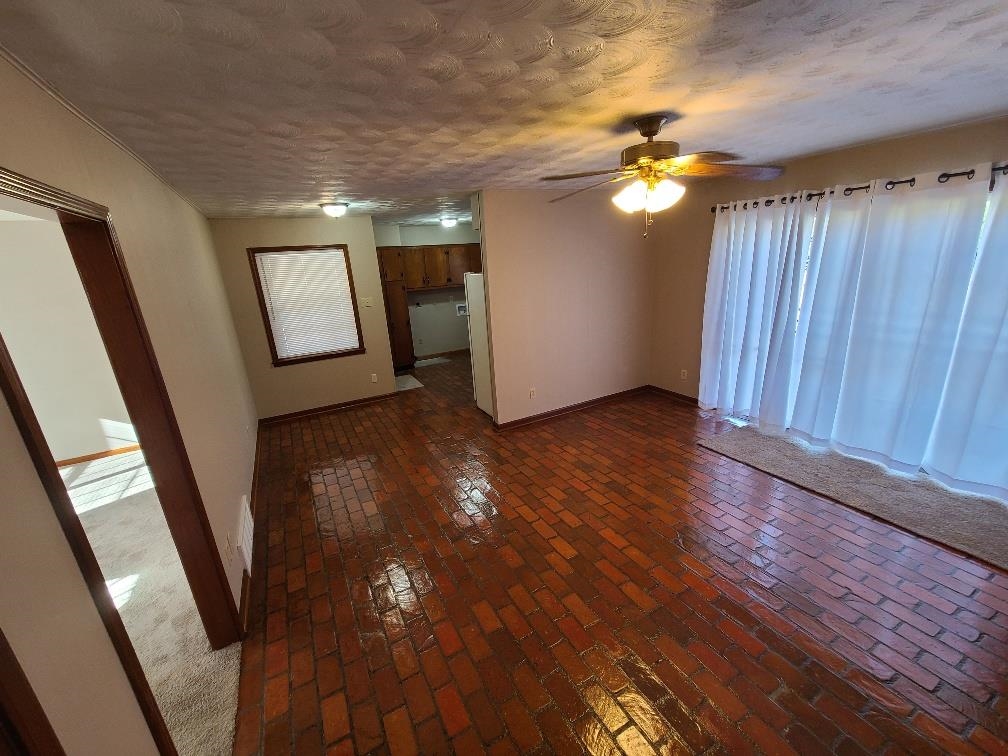 3478 Cane Ridge Drive Memphis, TN 38109 - Photo 3 of 19 wooden floor in an empty room with a window