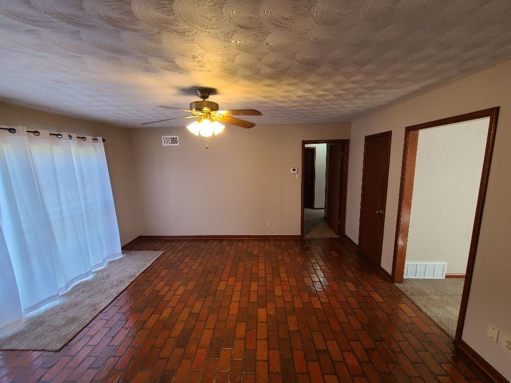 3478 Cane Ridge Drive Memphis, TN 38109 - Photo 4 of 19 wooden floor in an empty room with a window