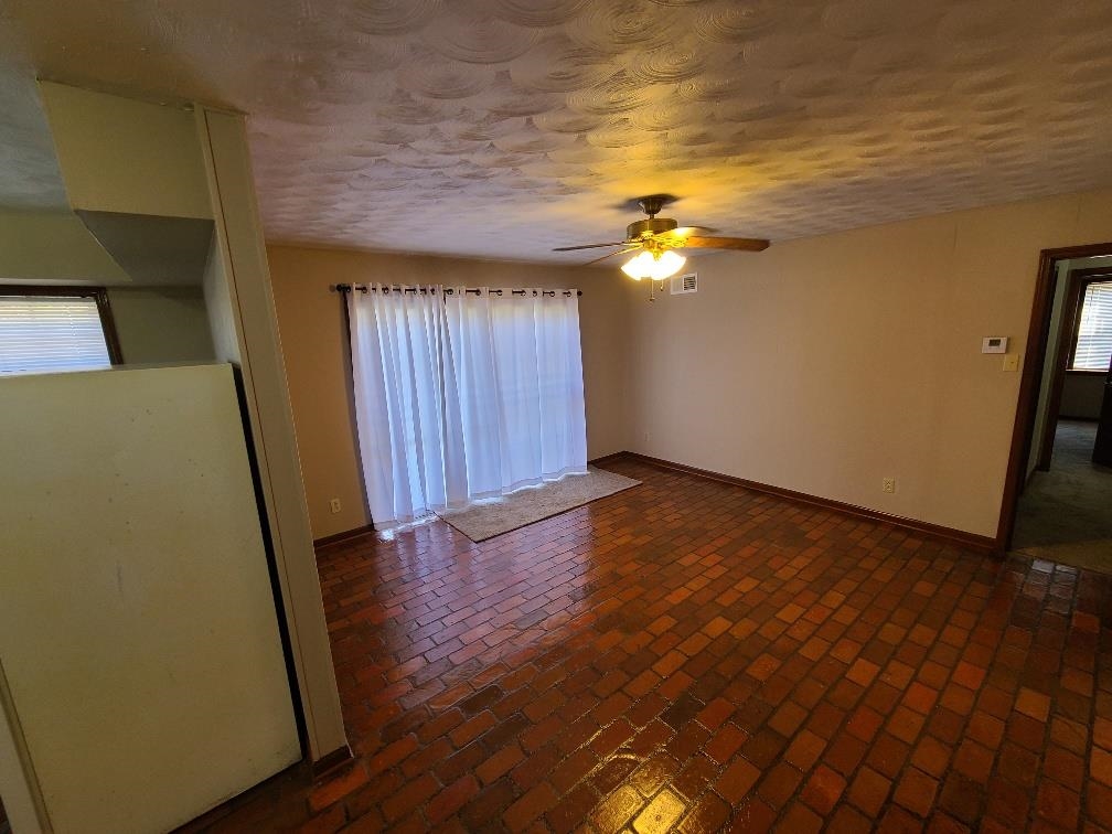 3478 Cane Ridge Drive Memphis, TN 38109 - Photo 5 of 19 an empty room with wooden floor and windows