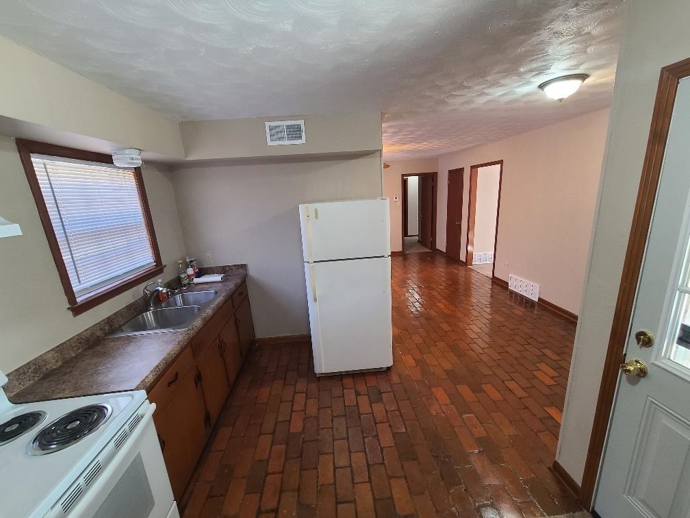 3478 Cane Ridge Drive Memphis, TN 38109 - Photo 8 of 19 a kitchen with a refrigerator and a stove