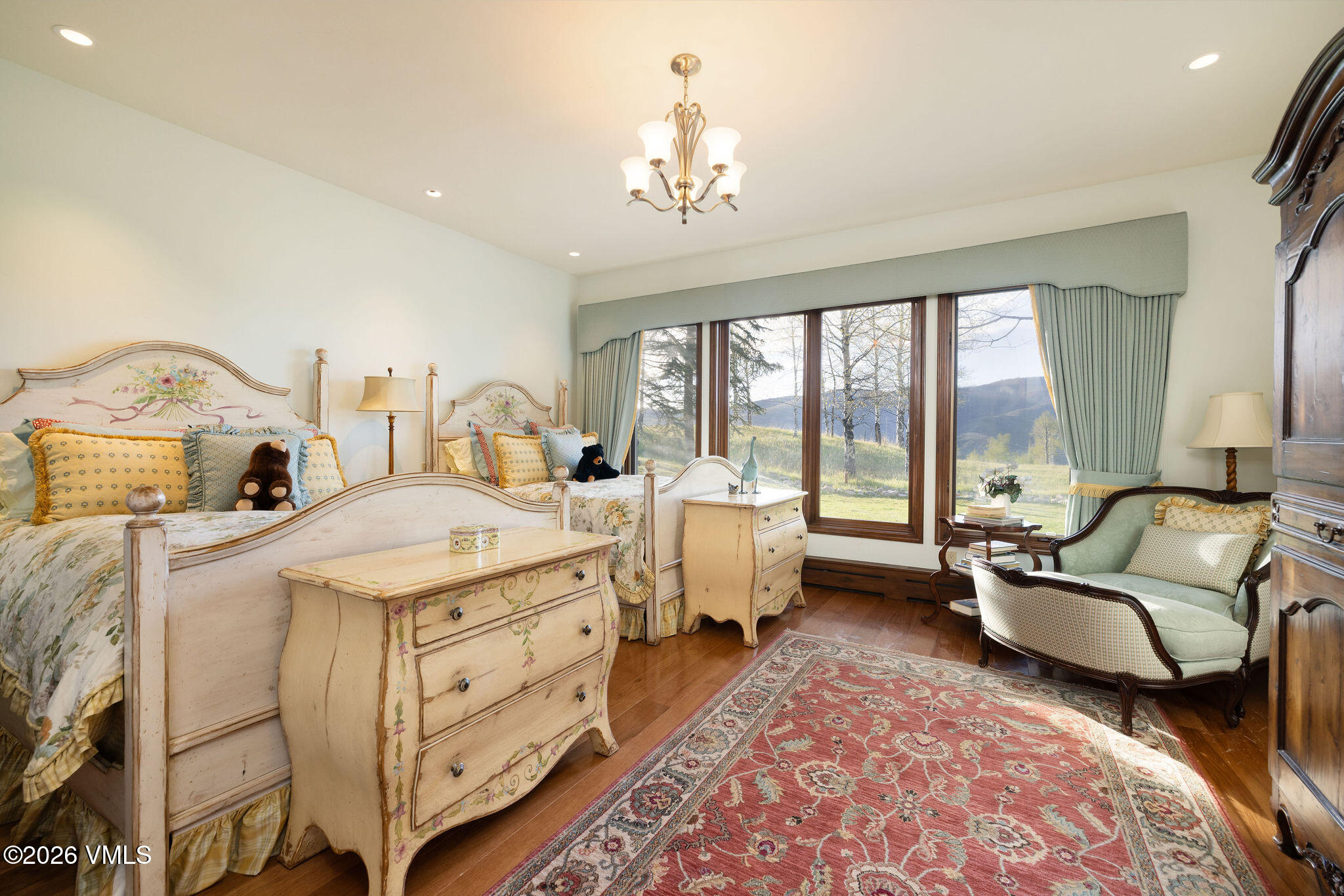 102 Saddle Ridge Loop Edwards, CO 81632 - Photo 13 of 29 a spacious bedroom with a bed and a chandelier