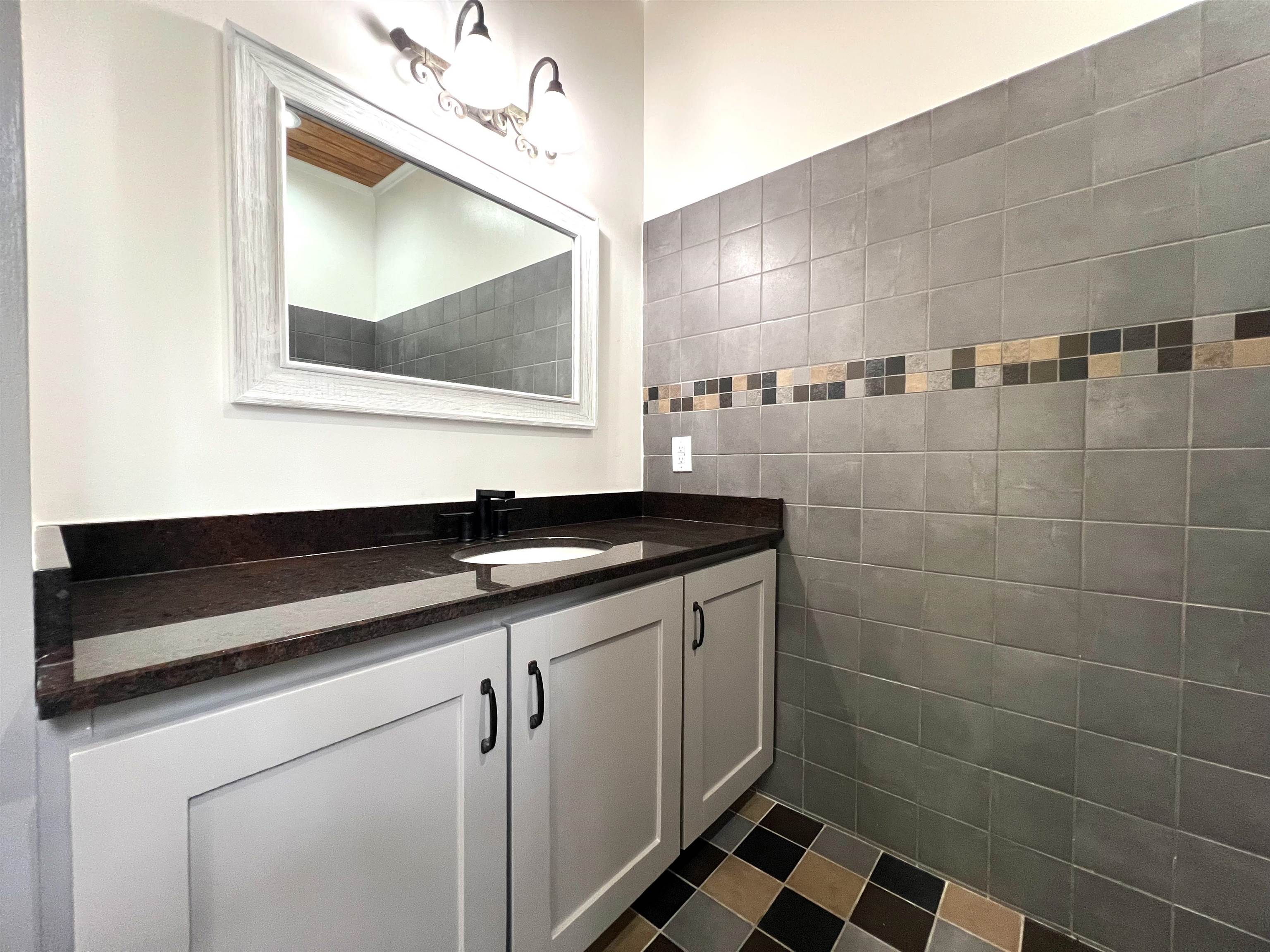 9490 Highway 196 Collierville, TN 38017 - Photo 22 of 39 Bathroom with vanity and tile walls