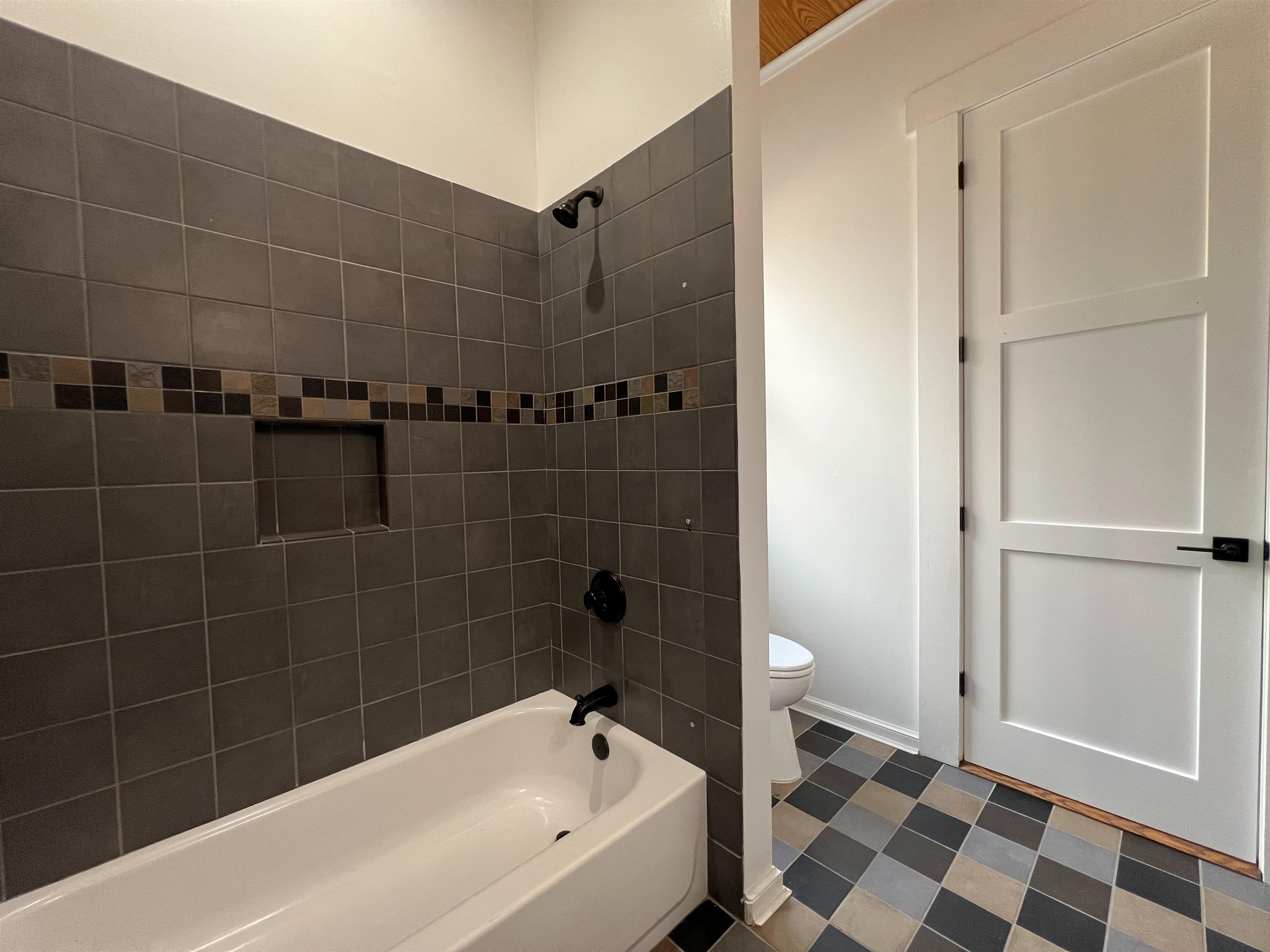 9490 Highway 196 Collierville, TN 38017 - Photo 24 of 39 Bathroom with dark flooring and shower / washtub combination