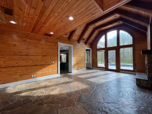 9490 Highway 196 Collierville, TN 38017 - Photo 3 of 39 Den with wood walls, stone flooring, a high wood beamed ceiling, plenty of natural light, and recessed lighting