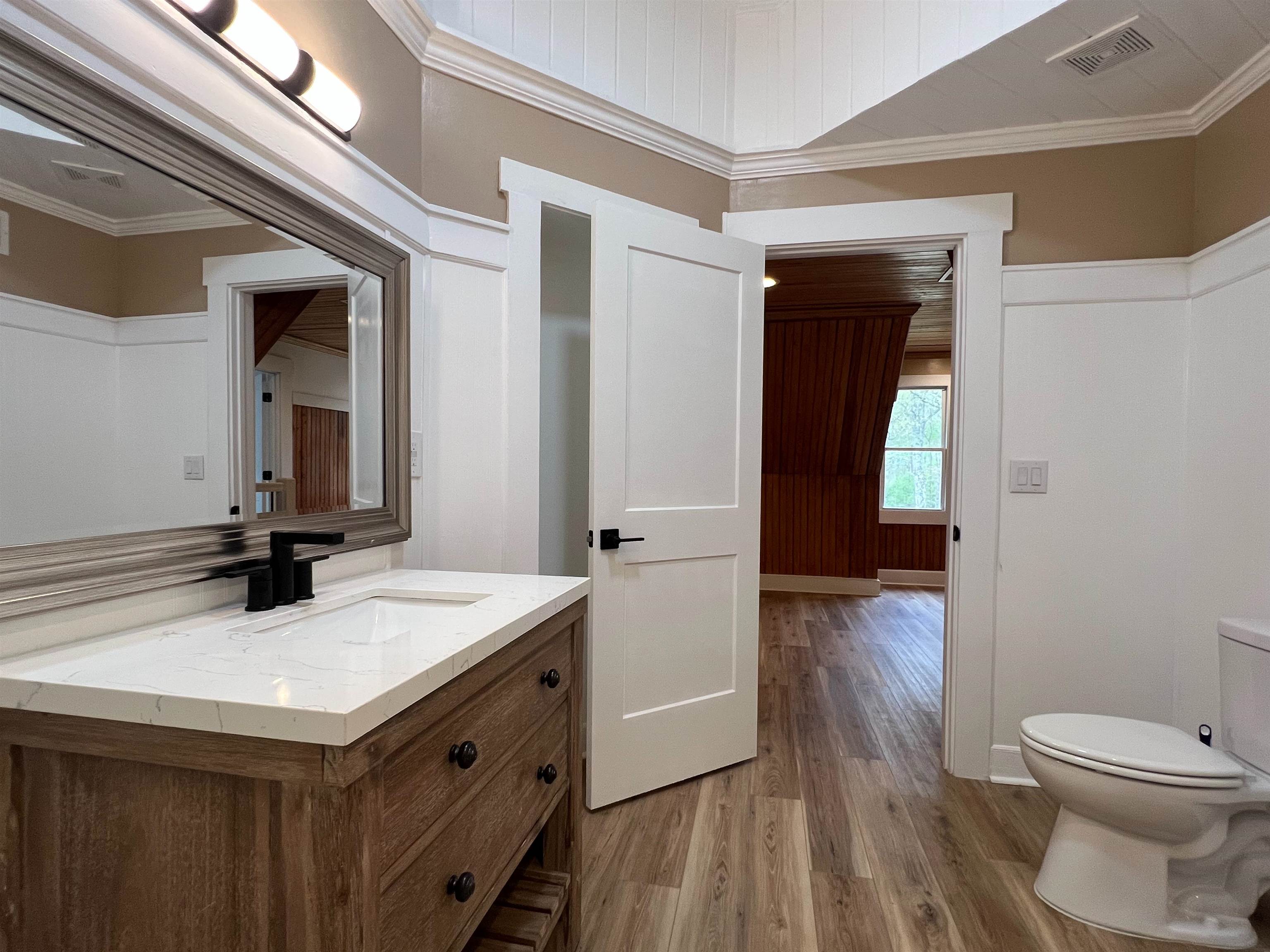 9490 Highway 196 Collierville, TN 38017 - Photo 32 of 39 Half bathroom with crown molding, vanity, and light wood-style floors
