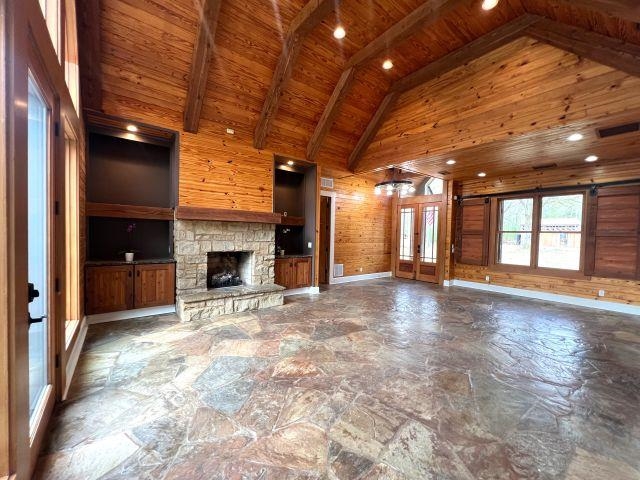 9490 Highway 196 Collierville, TN 38017 - Photo 6 of 39 Den featuring barn door window, wood walls, recessed lighting, stone flooring, French doors, and a fireplace