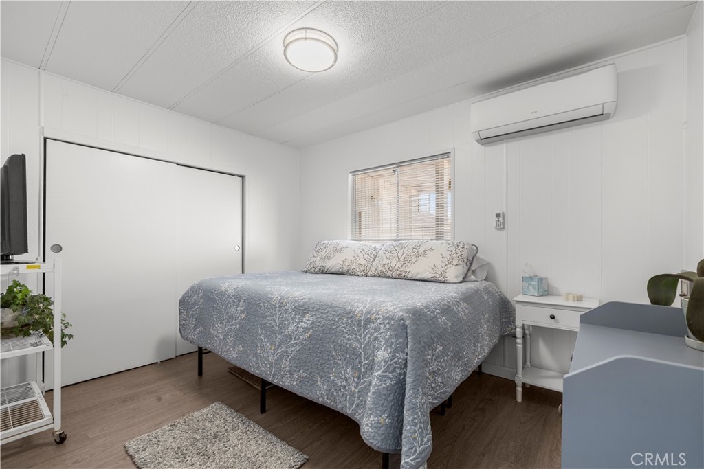 27150 Shadel Road, Unit 122 Menifee, CA 92586 - Photo 10 of 26 a bedroom with a bed and a table in it
