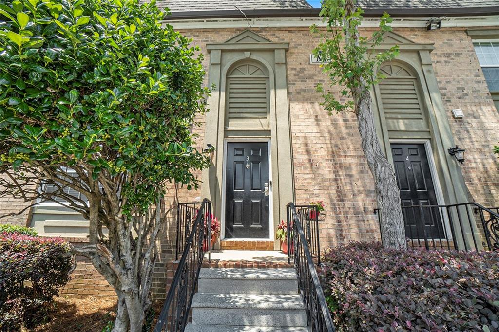 6980 Roswell Road, Unit M3 Sandy Springs, GA 30328 - Photo 1 of 1 a front view of a house with a tree