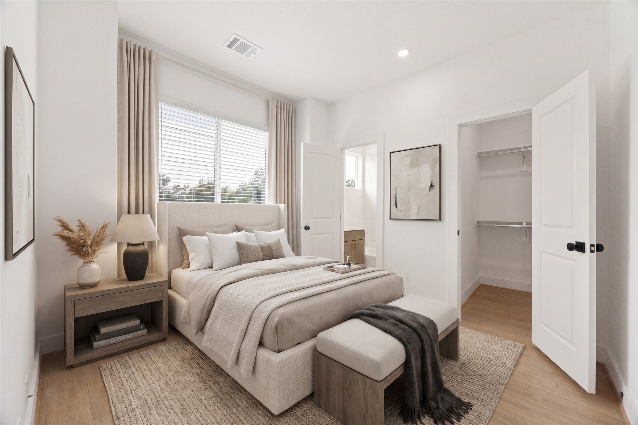 2121 Hoskins Drive, Unit C Houston, TX 77080 - Photo 5 of 34 Spacious upper-level bedroom with high ceilings, recessed lighting, warm wood-look flooring, large windows, and a walk-in closet with built-in shelving. The neutral palette and generous proportions create a calm, comfortable retreat ready for a variety of furniture layouts and personal styling. This photo has been virtually staged for visual reference.