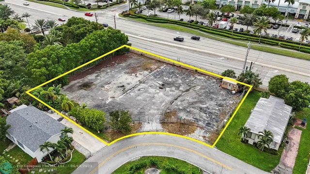 a view of a yard with a wooden fence