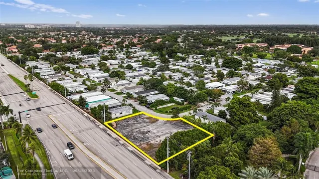 an aerial view of multiple houses with a yard