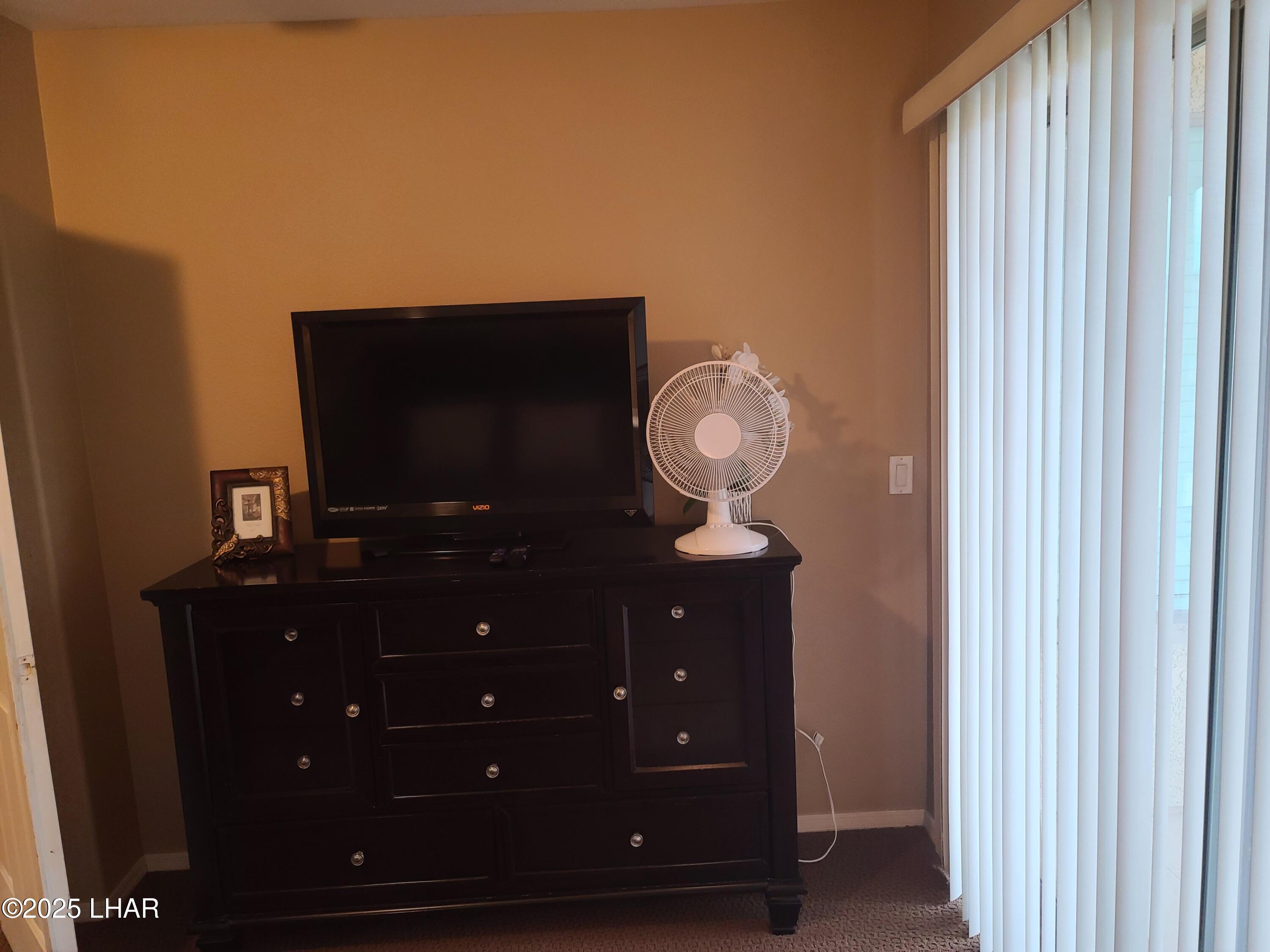 94 London Bridge Road, Unit 108 Lake Havasu City, AZ 86403 - Photo 25 of 38 a living room with furniture and a flat screen tv