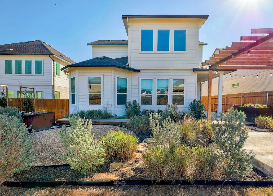 4705 Sea Salt Drive Austin, TX 78747 - Photo 16 of 19 Back of house featuring a pergola and a patio area