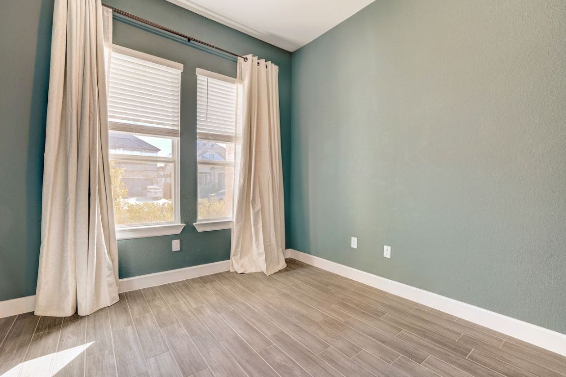 4705 Sea Salt Drive Austin, TX 78747 - Photo 3 of 19 Empty room featuring wood tiled floors