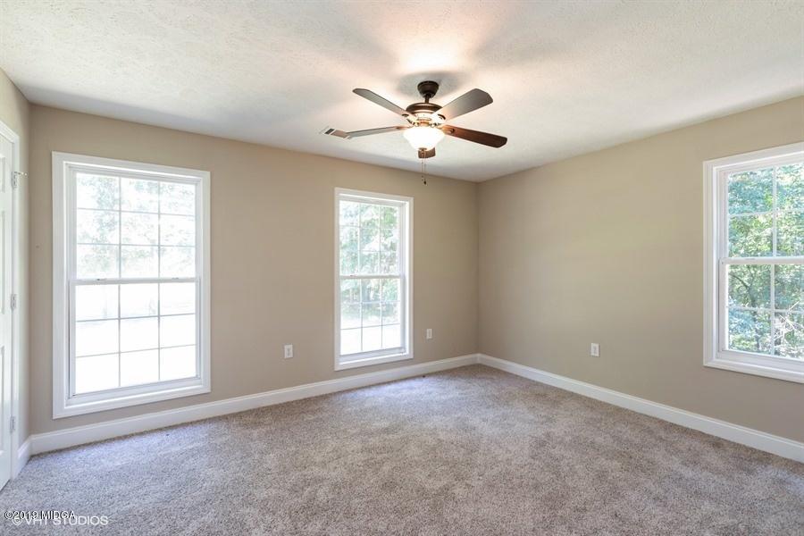 4071 Hollis Road Roberta, GA 31078 - Photo 14 of 22 an empty room with windows and ceiling fan