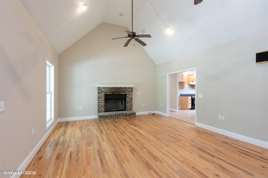 4071 Hollis Road Roberta, GA 31078 - Photo 3 of 22 a view of empty room with wooden floor and fireplace