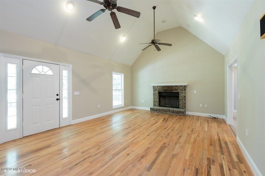 4071 Hollis Road Roberta, GA 31078 - Photo 5 of 22 a view of empty room with wooden floor and fireplace