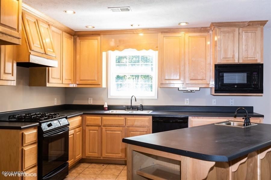 4071 Hollis Road Roberta, GA 31078 - Photo 7 of 22 a kitchen with stainless steel appliances a sink stove and microwave