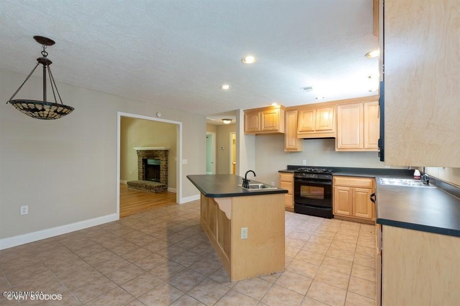 4071 Hollis Road Roberta, GA 31078 - Photo 8 of 22 a kitchen with stainless steel appliances granite countertop a sink and a refrigerator