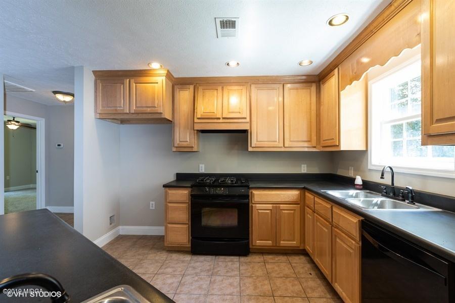 4071 Hollis Road Roberta, GA 31078 - Photo 10 of 22 a kitchen with granite countertop a stove a sink and a cabinets