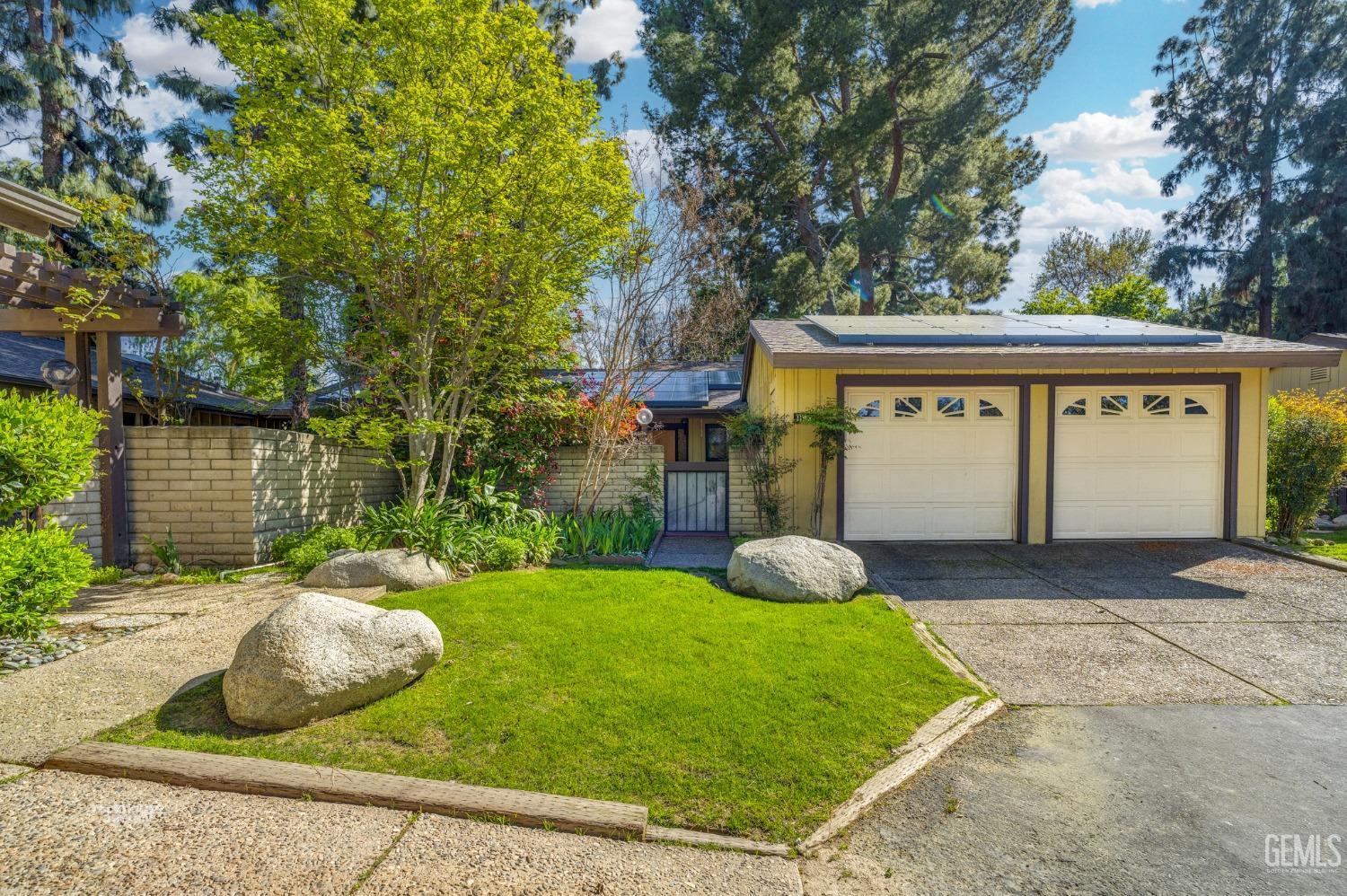 a front view of a house with garden