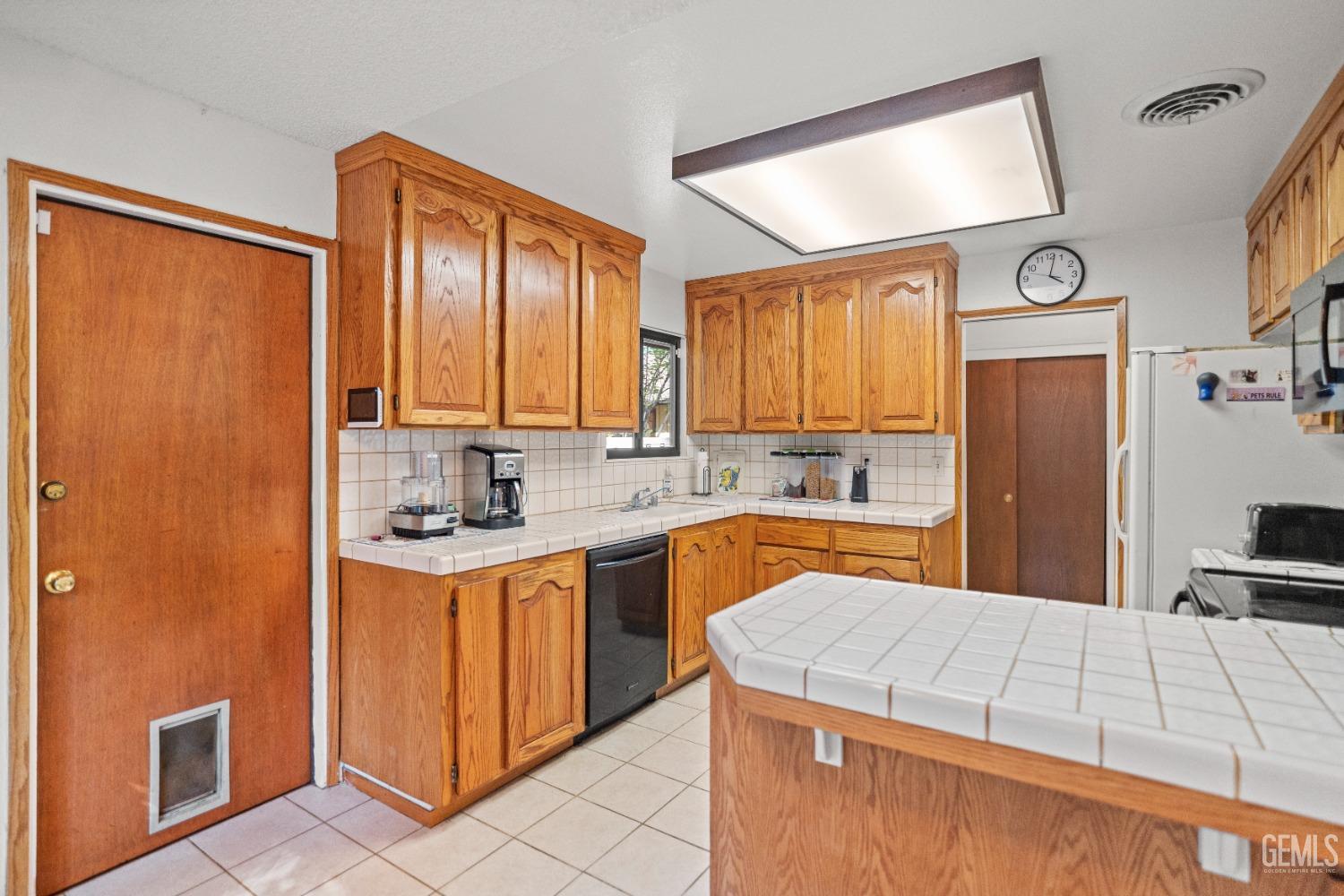 Undisclosed Address Bakersfield, CA 93306 - Photo 20 of 56 a kitchen with stainless steel appliances granite countertop a refrigerator a sink dishwasher a stove with wooden cabinets and floor