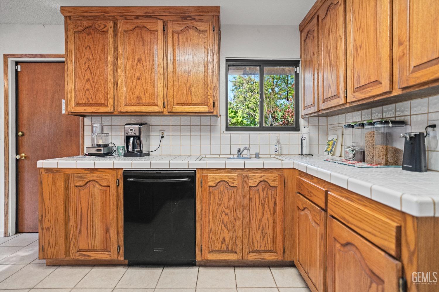 Undisclosed Address Bakersfield, CA 93306 - Photo 23 of 56 a kitchen with stainless steel appliances granite countertop a sink stove and cabinets