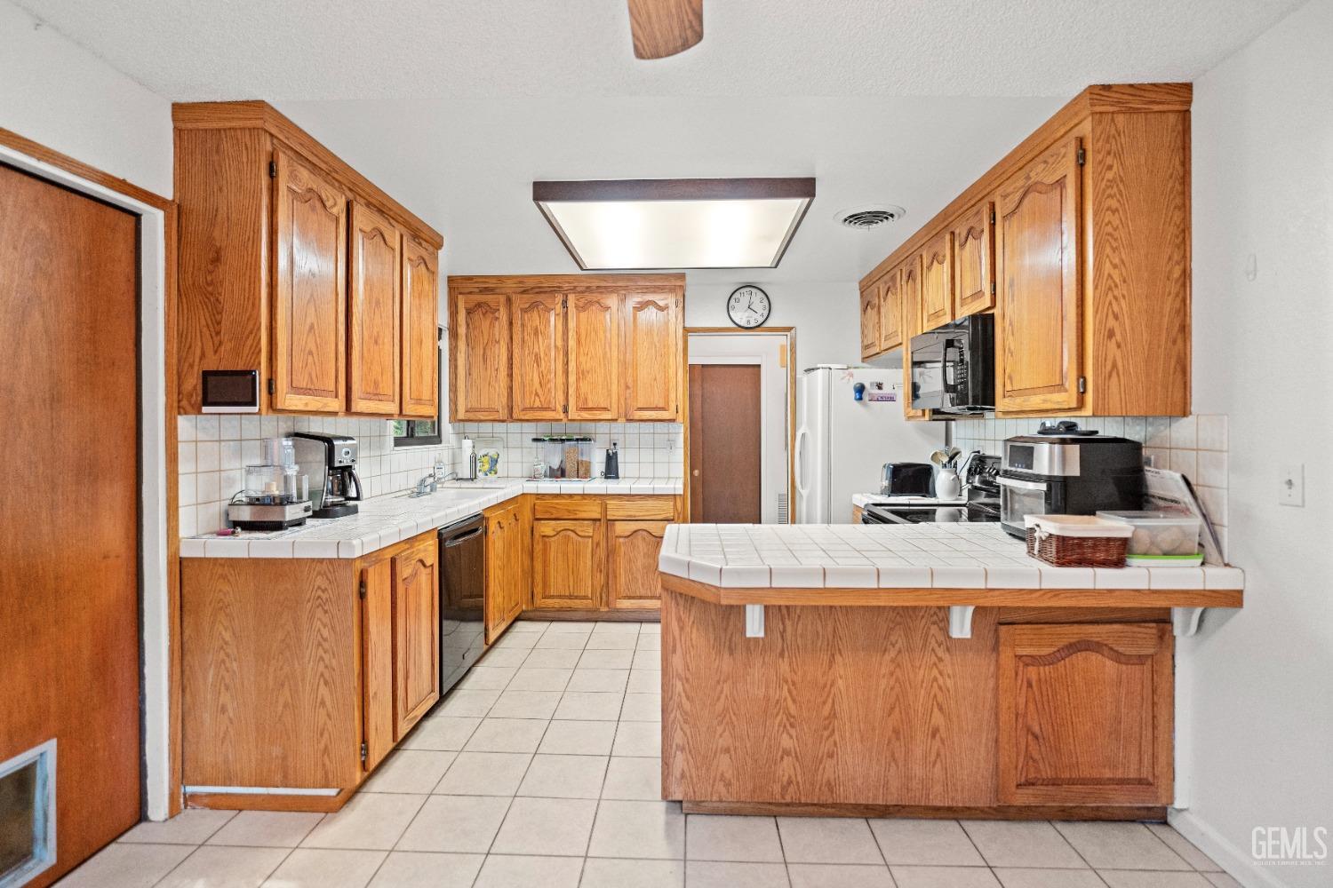 Undisclosed Address Bakersfield, CA 93306 - Photo 25 of 56 a kitchen with stainless steel appliances granite countertop a sink stove and refrigerator