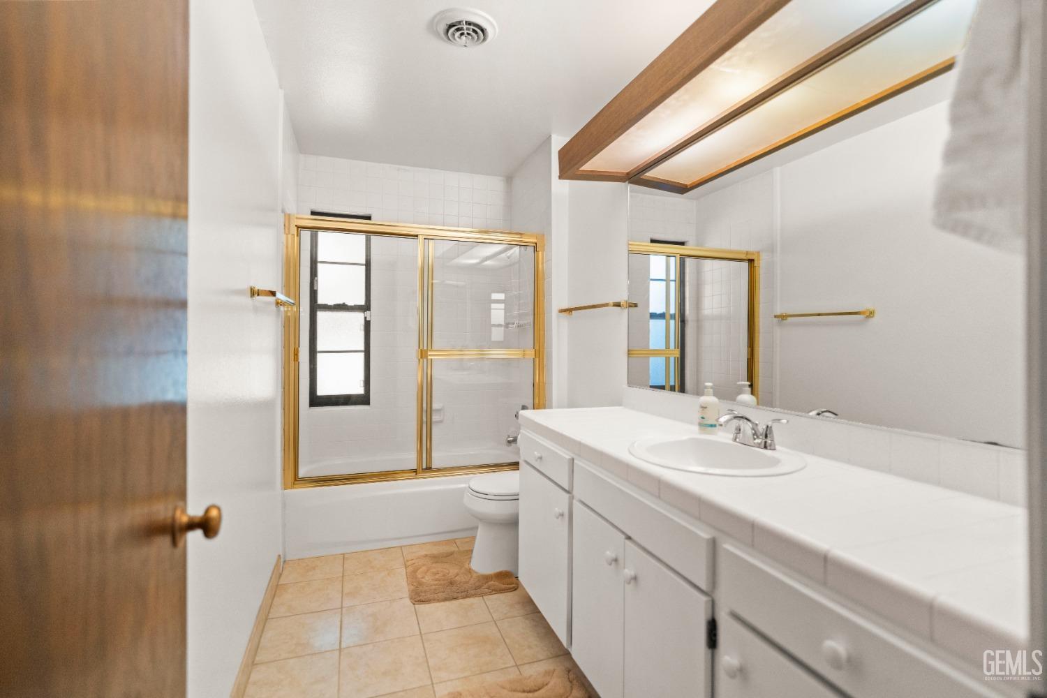 Undisclosed Address Bakersfield, CA 93306 - Photo 26 of 56 a spacious bathroom with a shower sink and mirror