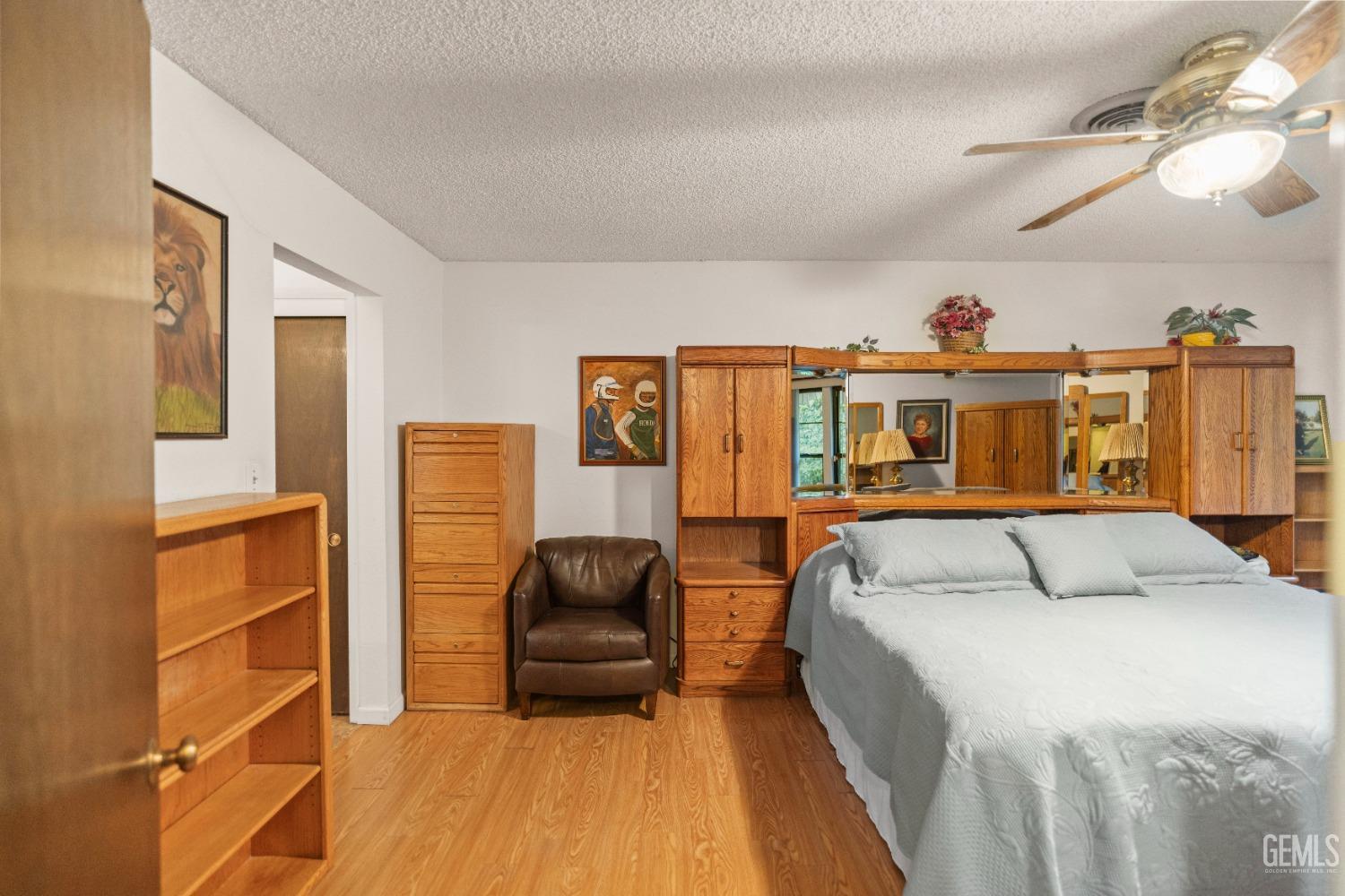 Undisclosed Address Bakersfield, CA 93306 - Photo 29 of 56 a bedroom with a bed and wooden floor