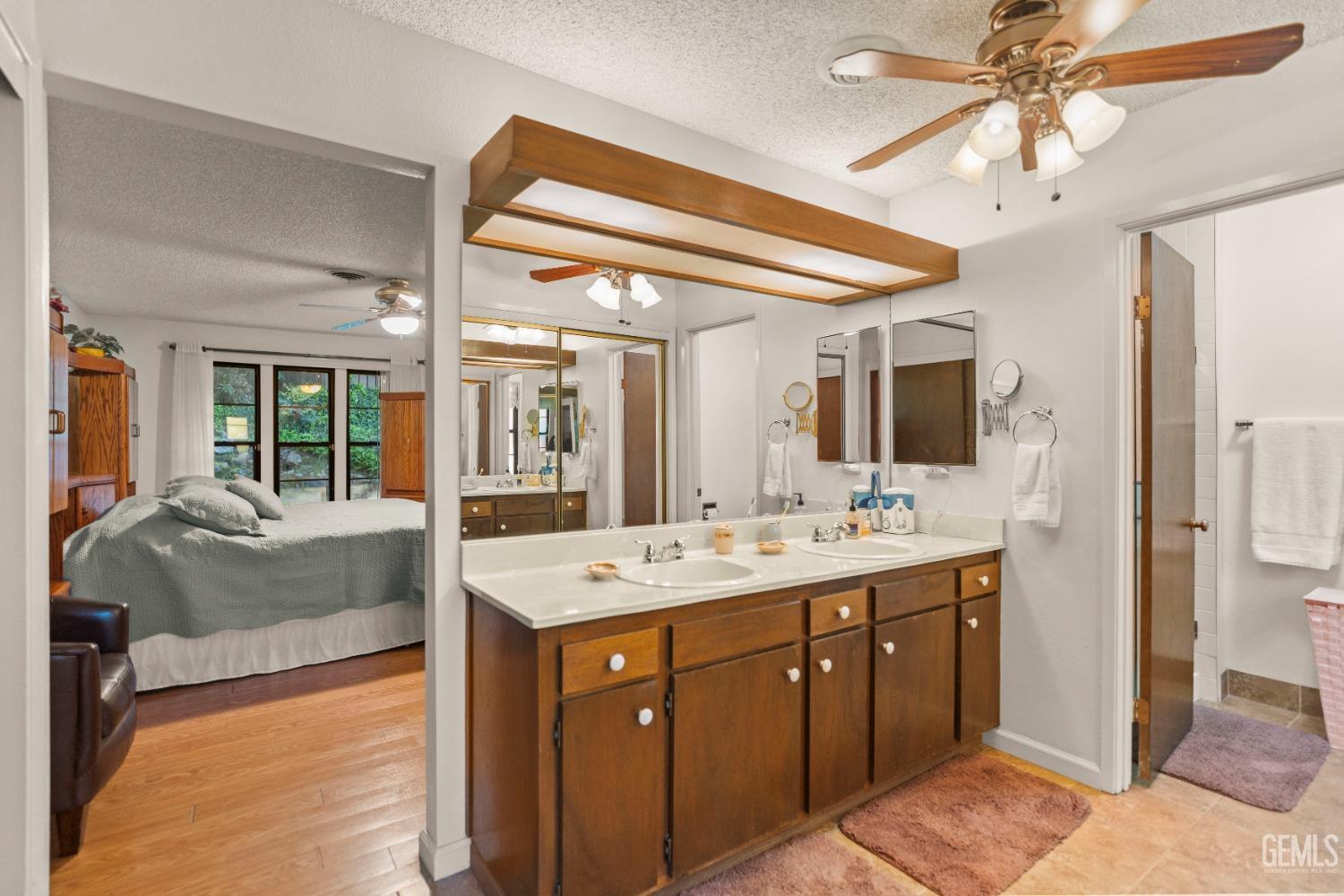 Undisclosed Address Bakersfield, CA 93306 - Photo 33 of 56 a spacious bathroom with a granite countertop sink mirror and bathtub