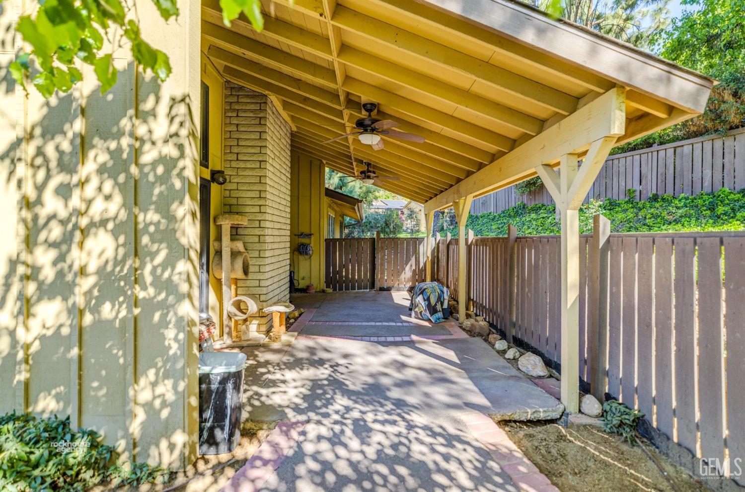 Undisclosed Address Bakersfield, CA 93306 - Photo 36 of 56 a view of a backyard with table and chairs and wooden fence