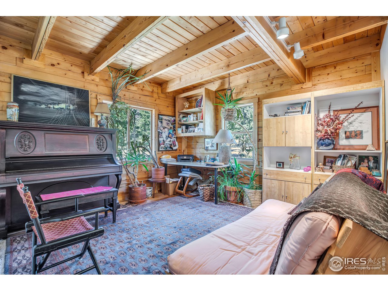 92 Tilghman Road Ward, CO 80481 - Photo 6 of 31 a bedroom with furniture and a flat screen tv